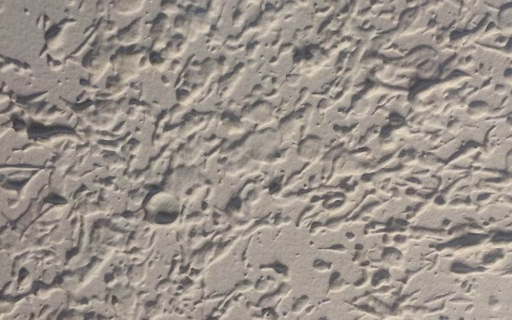 Close view of a heavily textured white ceiling